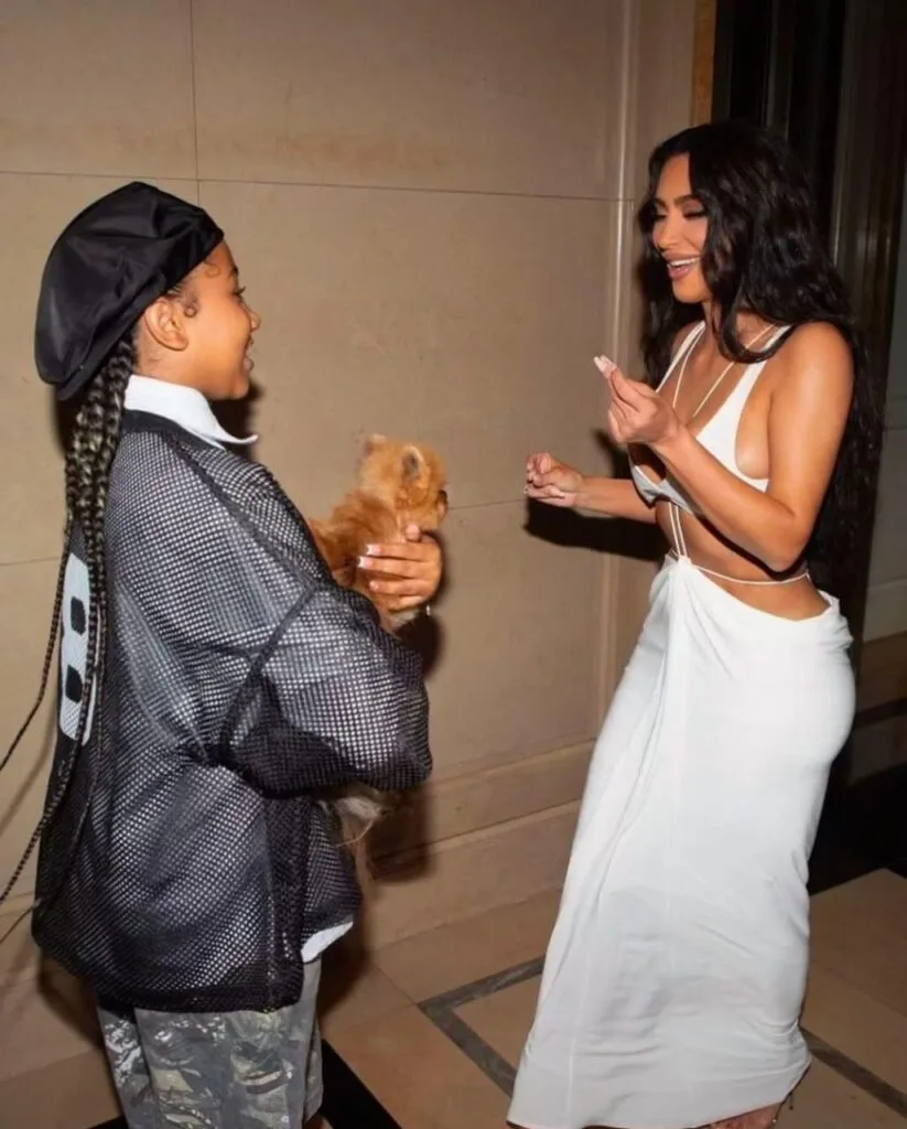 Kim Kardashian and North West posing pomeranian cuddled